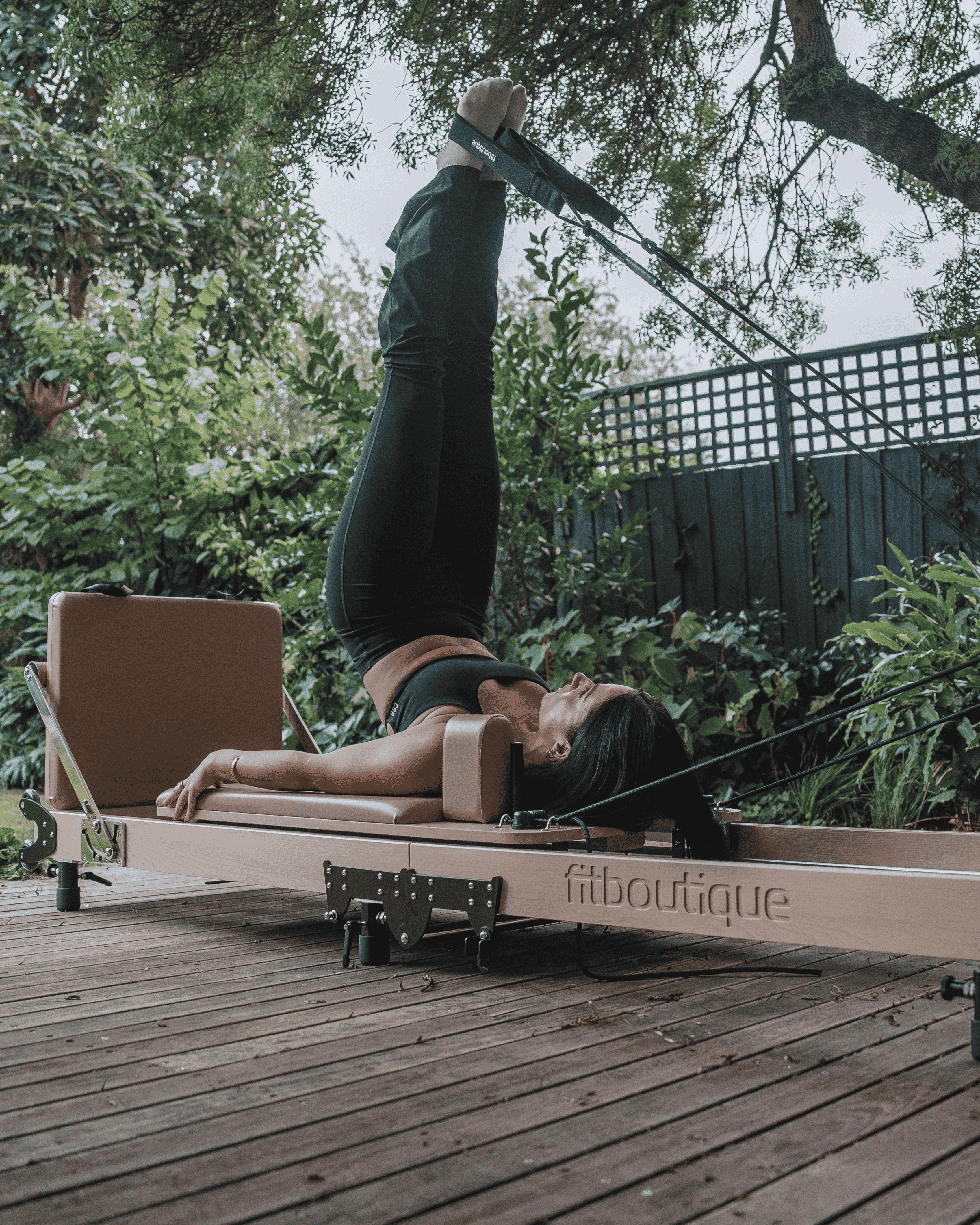 Woman Doing Overhead Exercise in Maple Crest Reformer