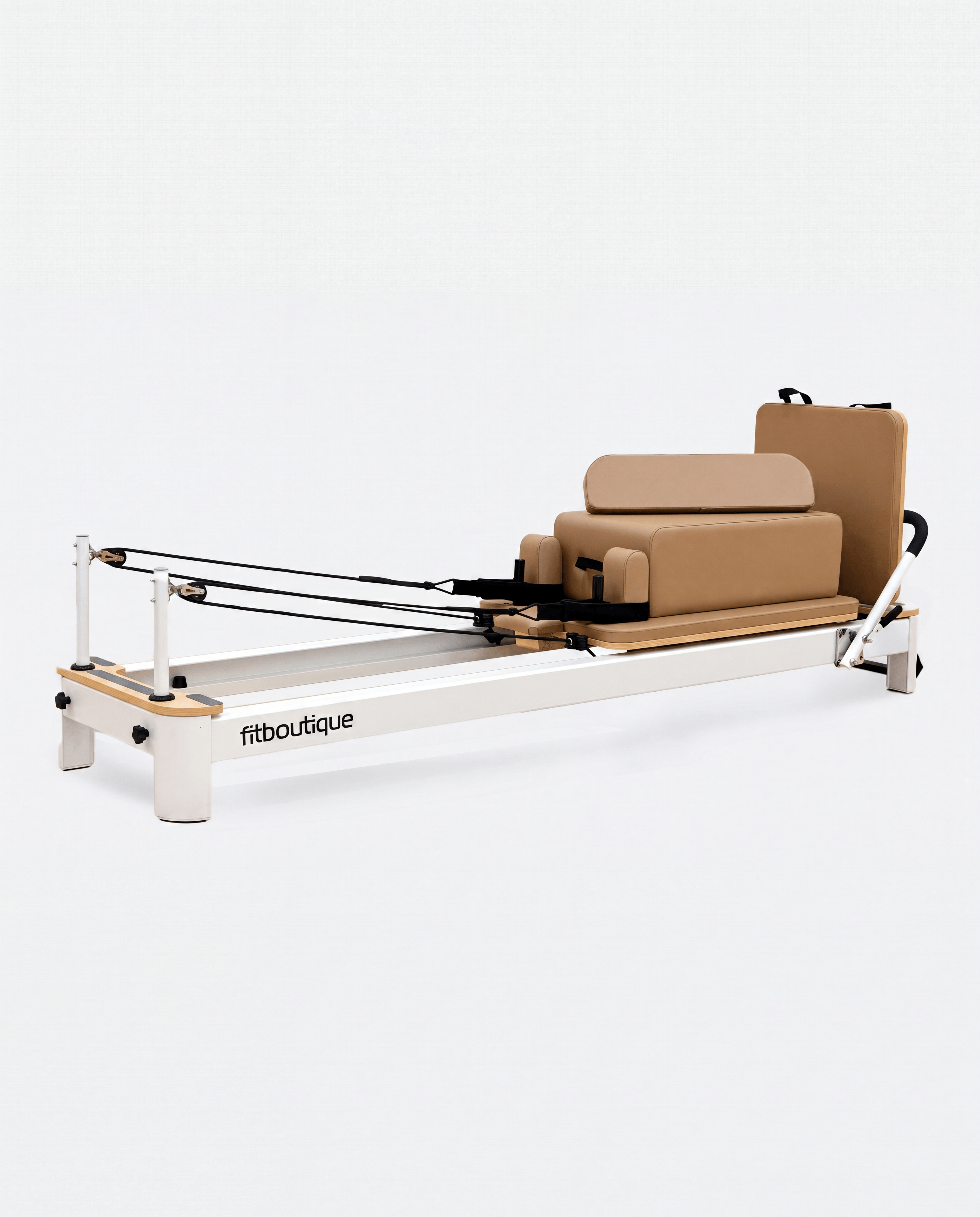 A Pilates reformer machine with a white metal frame, tan padded seat and backrest